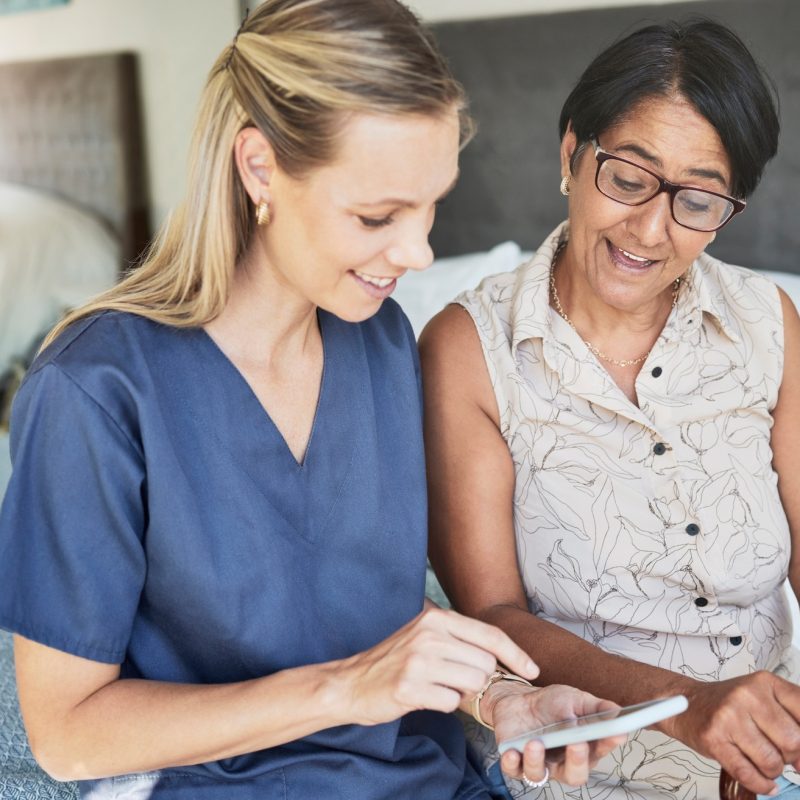 Happy woman, nurse and phone in elderly care for consultation, support or healthcare diagnosis at h